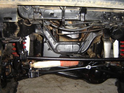 1989 Ford Bronco - Close-up view of a vehicle's undercarriage, showing suspension and steering components.