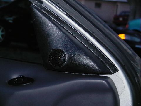 1999 Ford Taurus - The A-pillar trim piece has a small speaker integrated into it, with a door lock switch visible below.
