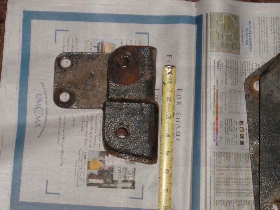 Metal bracket with tape measure showing 4 inches