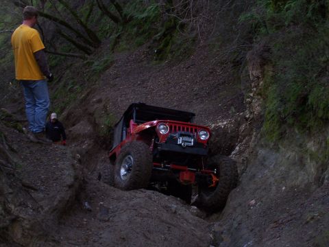 1998 Ford Ranger - Off-road Jeep tackling a challenging dirt path with onlookers present.