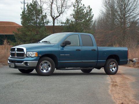 2004 Dodge 1500 - A blue 2004 Dodge Ram 1500 pickup truck is parked on a paved surface.