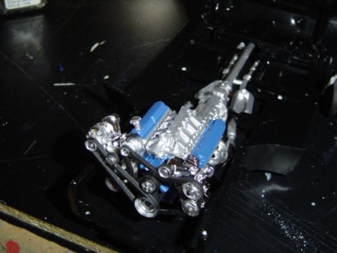 1979 Ford Bronco - A detailed model engine sits on a dark surface, possibly part of a larger project.