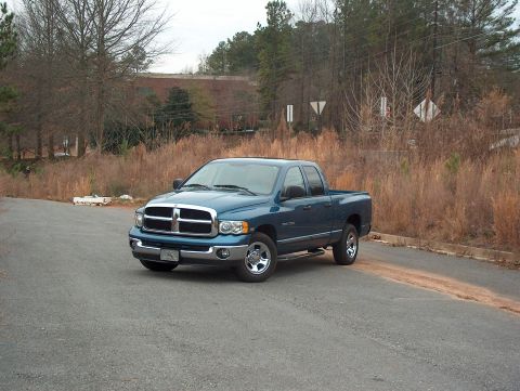 2004 Dodge 1500 - Blue 2004 Dodge 1500 pickup truck seen from a 3/4 front angle.