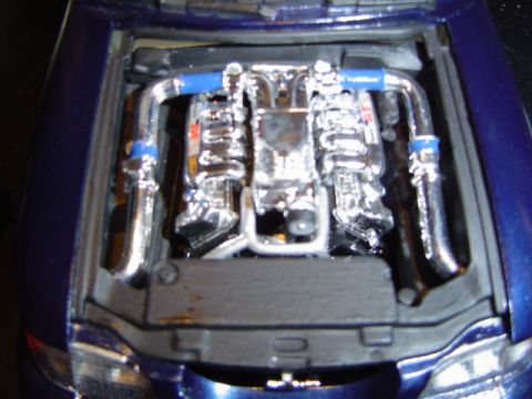 1979 Ford Bronco - Detailed model engine bay a V8 engine with chrome accents and blue hoses.