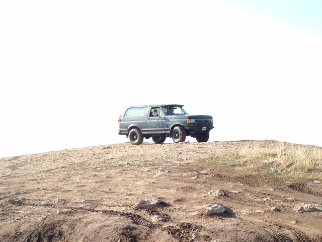 Gray 1991 Ford Bronco parked on a dirt hill