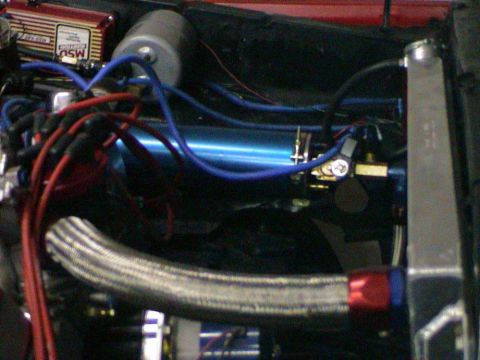 1979 Ford Bronco - Close-up of an engine bay an MSD ignition box and blue coolant lines, part of a custom build.