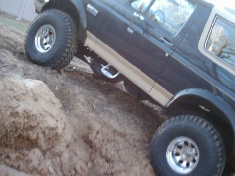 1989 Ford Bronco - This 1989 Ford Bronco is shown on a dirt track, equipped with large off-road tires.