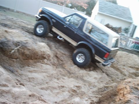 1989 Ford Bronco - This 1989 Ford Bronco is shown navigating a challenging dirt hill.
