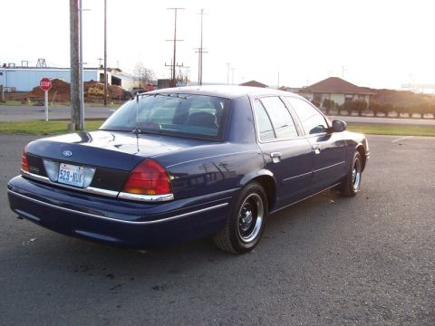 1998 Ford Crown Victoria - Dark blue 1998 Ford Crown Victoria parked outdoors with a stop sign in the background.