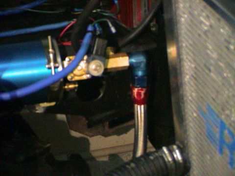 1979 Ford Bronco - Detail of engine components including fuel lines and a radiator section.