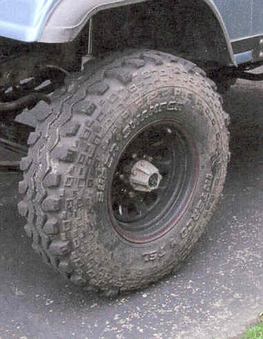 1984 Jeep Wrangler - A close-up view of a off-road tire, showing the 'SUPERIOR' and 'CHAMPION' tread pattern.