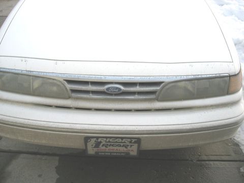 1997 Ford Crown Victoria - Front view of a white 1995 Ford Crown Victoria, showing the grille and headlights.
