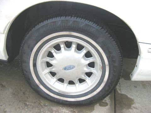 1997 Ford Crown Victoria - This image shows a close-up of a Ford wheel and tire, not a full vehicle.