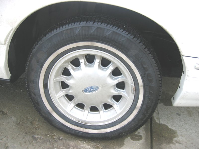 Close-up of a Ford wheel with a white stripe tire