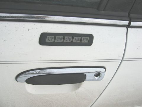1997 Ford Crown Victoria - Close-up of the keypad entry system and door handle on a 1997 Ford Crown Victoria.