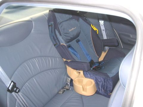 1997 Ford Crown Victoria - Child car seat secured in the rear passenger area of a vehicle.