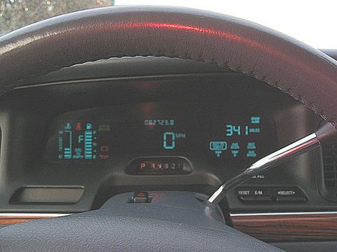 1997 Ford Crown Victoria - Interior view of a 1997 Ford Crown Victoria dashboard with digital readouts and a gear selector.