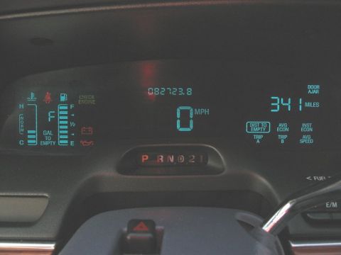 1997 Ford Crown Victoria - The digital dashboard displays the speed at 0 MPH, an odometer reading of 082723.8, and the fuel level.