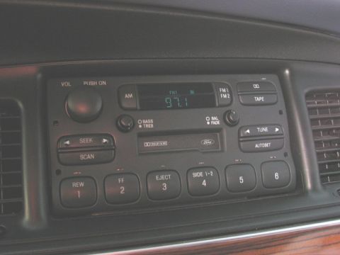 1997 Ford Crown Victoria - Close-up of a car's dashboard radio unit, a cassette deck and AM/FM tuner.