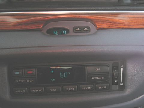1997 Ford Crown Victoria - The climate control panel and digital clock are visible in the vehicle's interior.