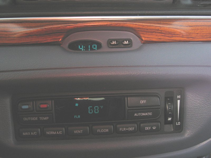 Dashboard digital clock reading 4:19 and automatic climate control display set to 68F