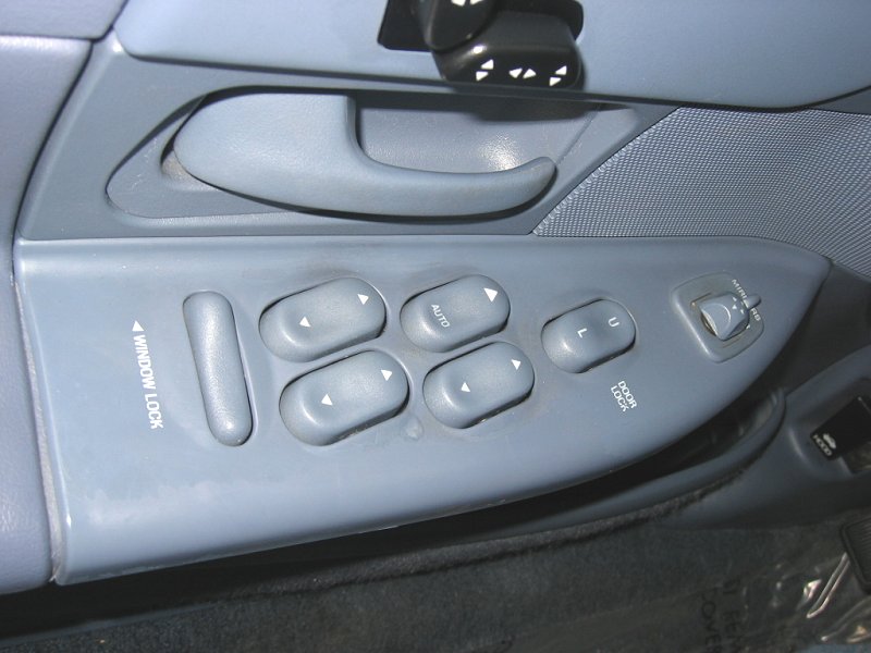 1997 Ford Crown Victoria interior door panel showing window lock, auto window, and door lock buttons