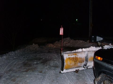 1985 Ford F-150 - A truck equipped with a snow plow is seen at night, ready for winter conditions.