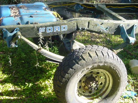 1989 Ford Bronco - The "FORD" lettering is visible on the chassis of this vehicle part.