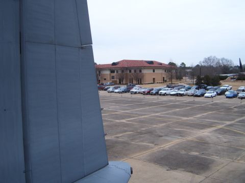 1988 Ford Bronco - A parking lot filled with vehicles is seen from the perspective of a large aircraft's tail section.