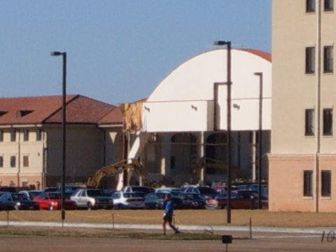 1988 Ford Bronco - A construction site is visible with heavy machinery and a lot of cars parked nearby.