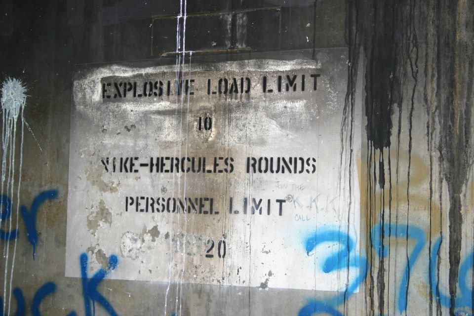 Stenciled concrete bunker wall reading Explosive Load Limit Nike-Hercules rounds