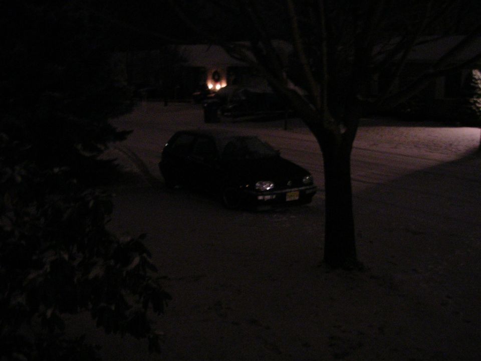 1996 Volkswagen GTI parked on snowy street at night