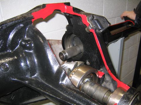 1978 Ford Bronco - Close-up inside a black-painted axle housing with a red sealant bead laid around the differential cover mating surface, showing the pinion…