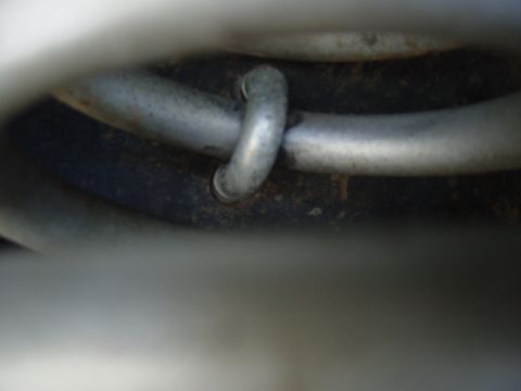 1979 Ford Bronco - Close-up view of looped metal pipes, likely part of a vehicle's cooling or exhaust system.
