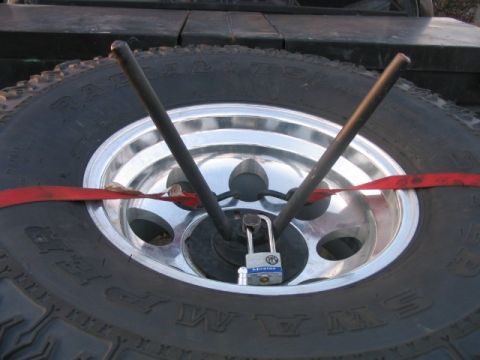 1986 Ford F-150 - Spare tire locked down with straps, likely for transport or security.
