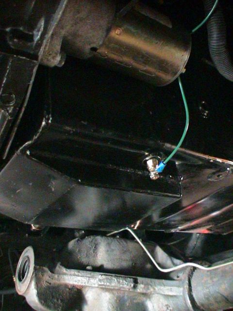 1979 Ford Bronco - Close-up view of engine bay components, including wiring and a starter motor.