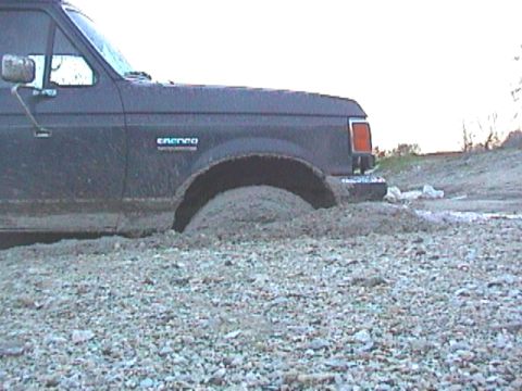 1989 Ford Bronco - This 1989 Ford Bronco is deeply stuck in mud, with its front wheel submerged.