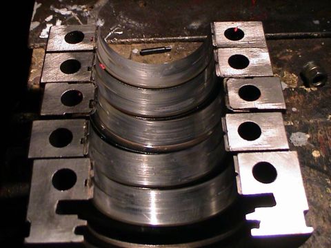 1979 Ford Bronco - Engine bearings are laid out on a workbench, ready for installation or inspection.