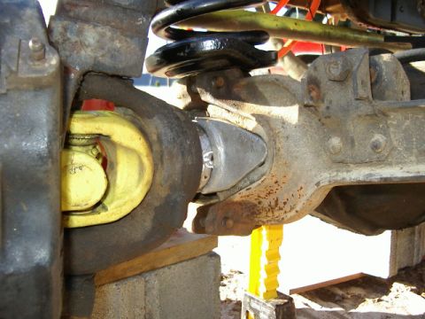 1985 Ford Bronco - Close-up view of a vehicle's driveshaft U-joint and differential housing.