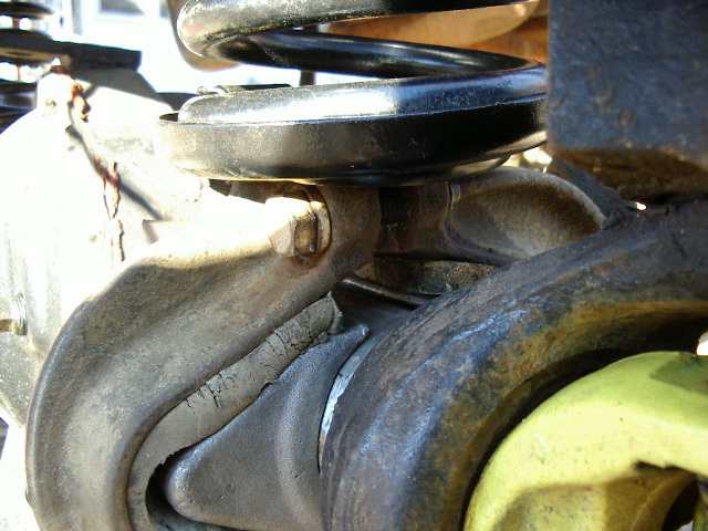 Close-up of vehicle suspension with a coil spring and metal components