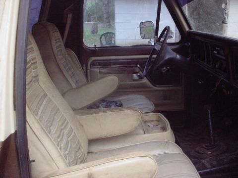1979 Ford Bronco - The interior of a 1979 Ford Bronco, bucket seats and a dashboard, is visible in this photograph.