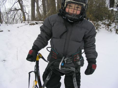 1986 Ford Bronco - Child dressed for winter activities holds an ice axe in a snowy forest.