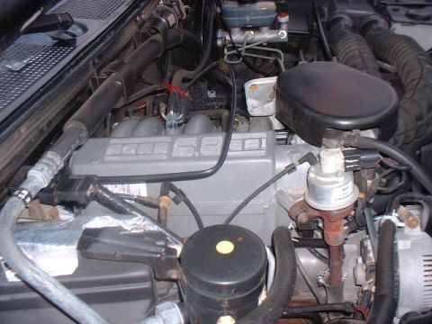 1995 Ford Bronco - Close-up view of the engine bay in a 1995 Ford Bronco, highlighting the 5.8L V8 engine components.