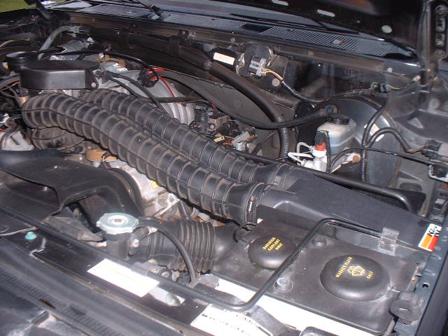 Engine bay with dual ribbed intake hoses and K&N sticker