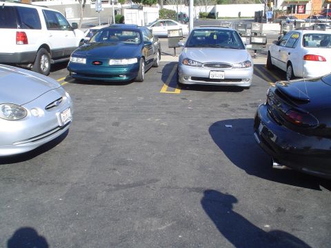 1993 Ford Taurus - 1993 Ford Taurus in a parking lot with other vehicles.