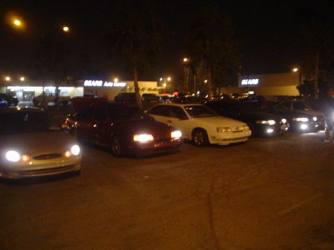 1993 Ford Taurus - A silver 1992 Ford Taurus is parked in front of a Sears Auto Center at night.