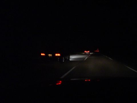 1993 Ford Taurus - Driving on the highway at night with other vehicles ahead.