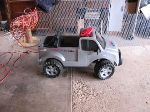 2004 Ford F-150 - A toy truck with FX4 decals sits on a concrete floor next to a coiled extension cord.