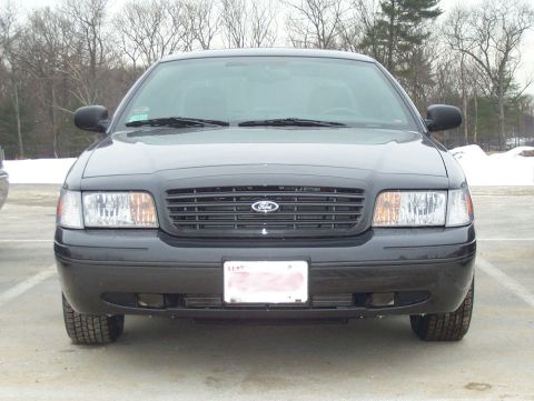 2001 Ford Crown Victoria - A 2001 Ford Crown Victoria is shown from the front in a parking lot with trees and snow in the background.