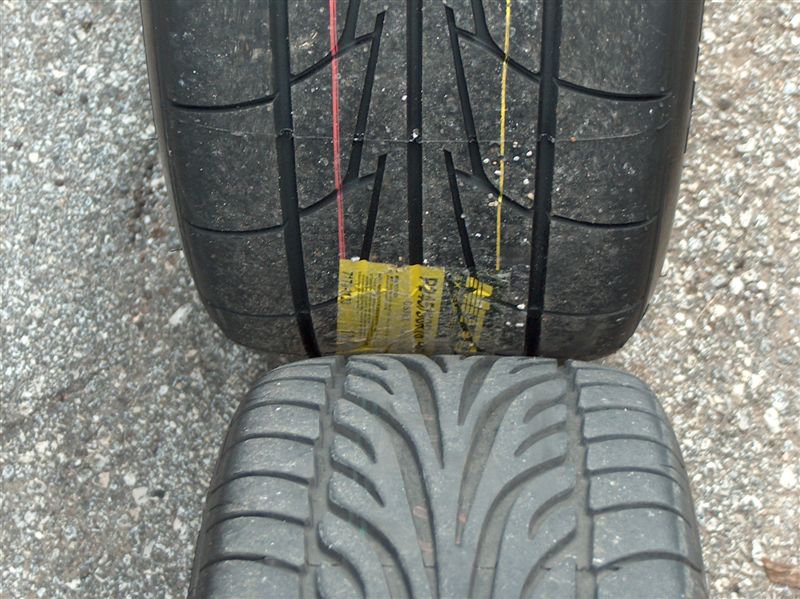 Overhead comparison of new labeled tire tread against a directional V-pattern tire